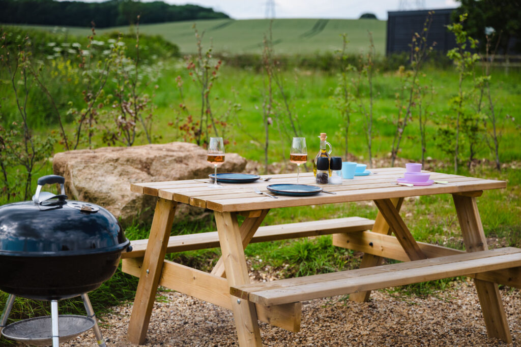Al fresco dining area with scenic countryside views at a luxury lodge in the East Midlands
