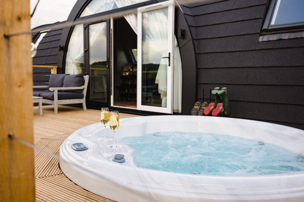 Luxury hospitality imagery of champagne by a hot tub, perfect for romantic getaway marketing