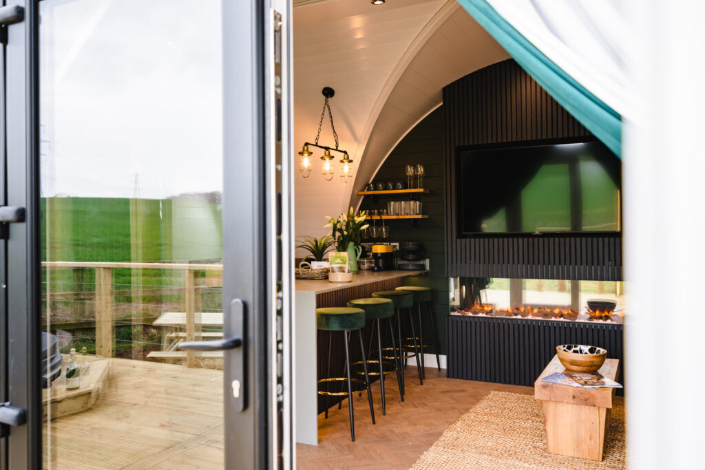 Cosy living area in a luxury Rutland lodge featuring a modern wood-burning fireplace and stylish interiors