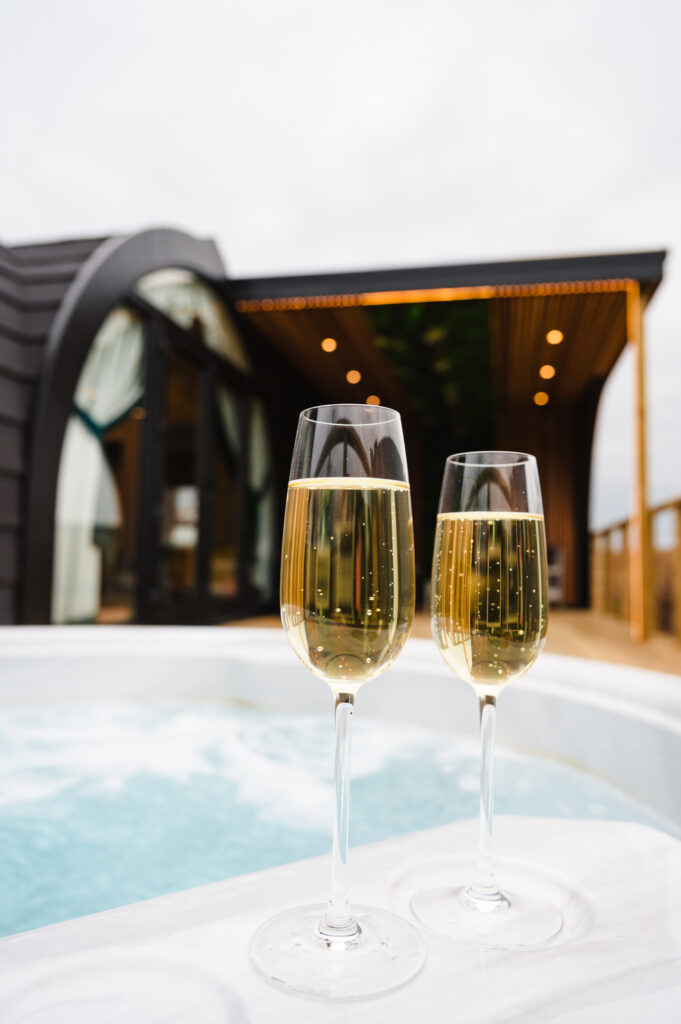 Luxury hospitality imagery of champagne by a hot tub, perfect for romantic getaway marketing