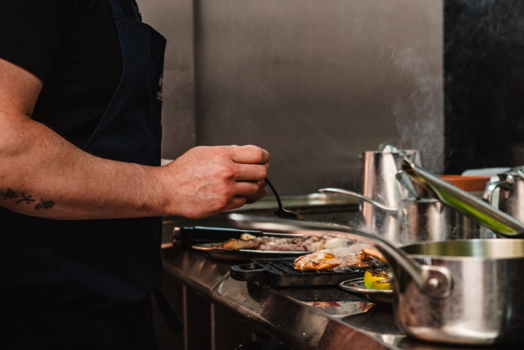 Candid photography of a chef in a busy East Midlands kitchen, perfect for hotel social media branding