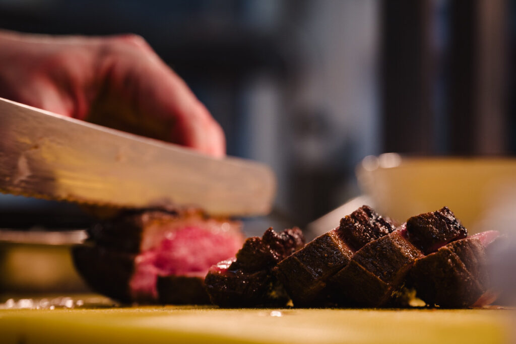chef cutting wagyu beef to serve