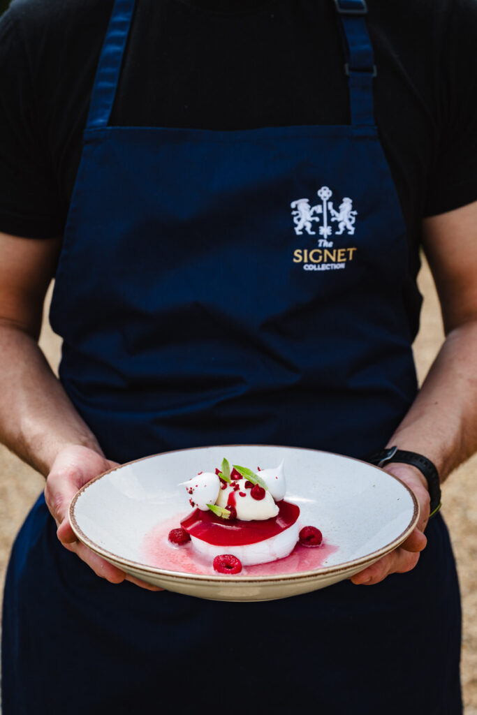 chef holding a plated desert at a beautiful boutique hotel restaurant in the east midlands